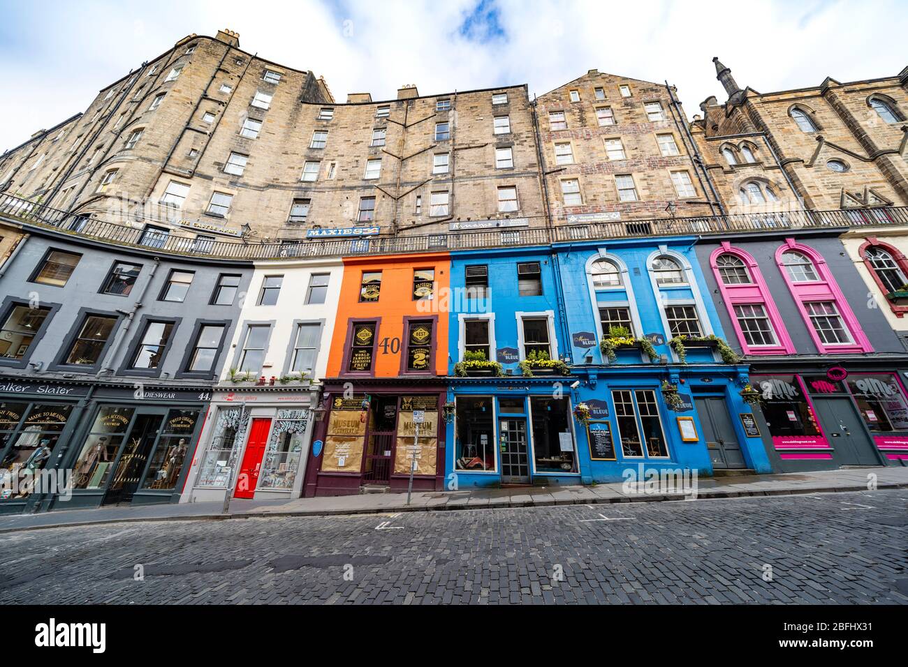 Edinburgh, Scotland, UK. 18 April 2020. Views of empty streets and members of the public outside on another Saturday during the coronavirus lockdown in Edinburgh. Shops and restaurants on Victoria Street are closed and street deserted. Iain Masterton/Alamy Live News Stock Photo