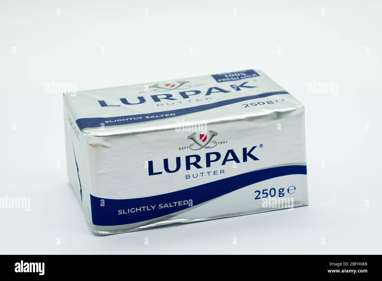 Irvine, Scotland, UK - April 18, 2020: A block of Lurpak branded slightly salted butter in recyclable wrapper made of foil and recyclable across most Stock Photo