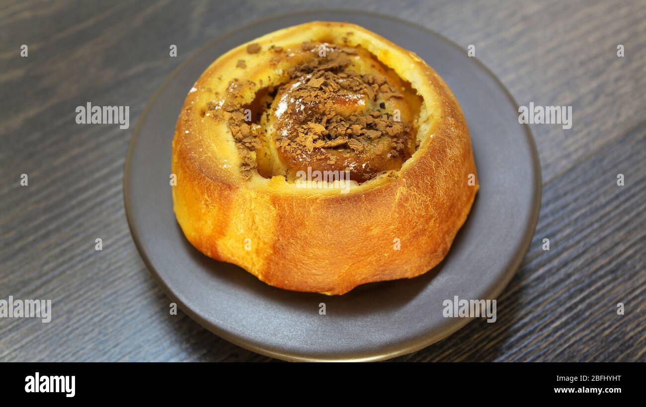 Chocolate bun on a wooden table Stock Photo