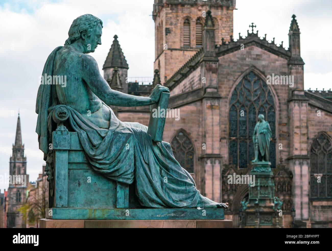 Statue of David Hume and St Giles Cathedral on the Royal Mile in Edinburgh Old Town, Scotland, UK Stock Photo