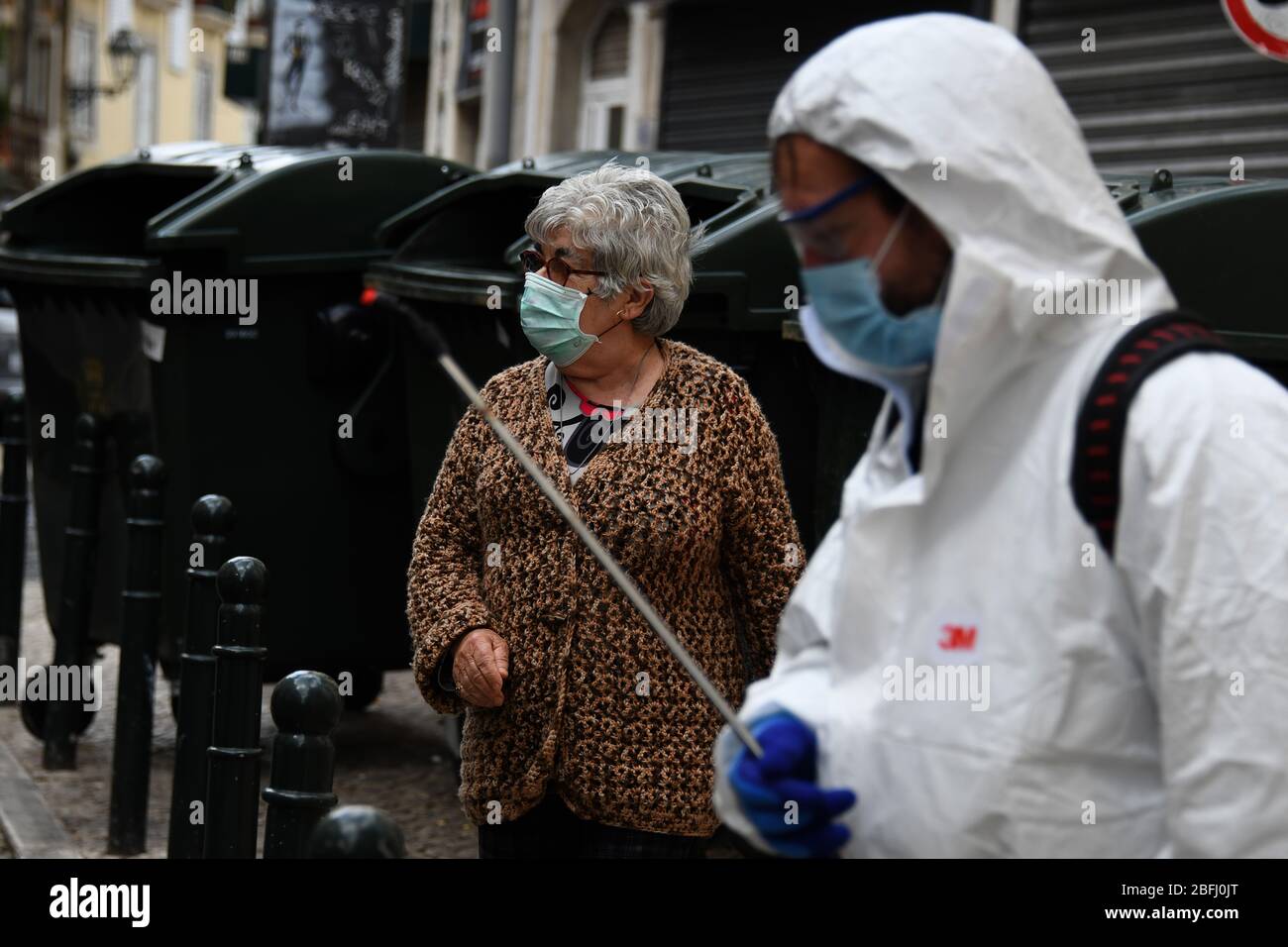 Lisbon, Portugal. 15th Apr, 2020. A worker disinfects while wearing a