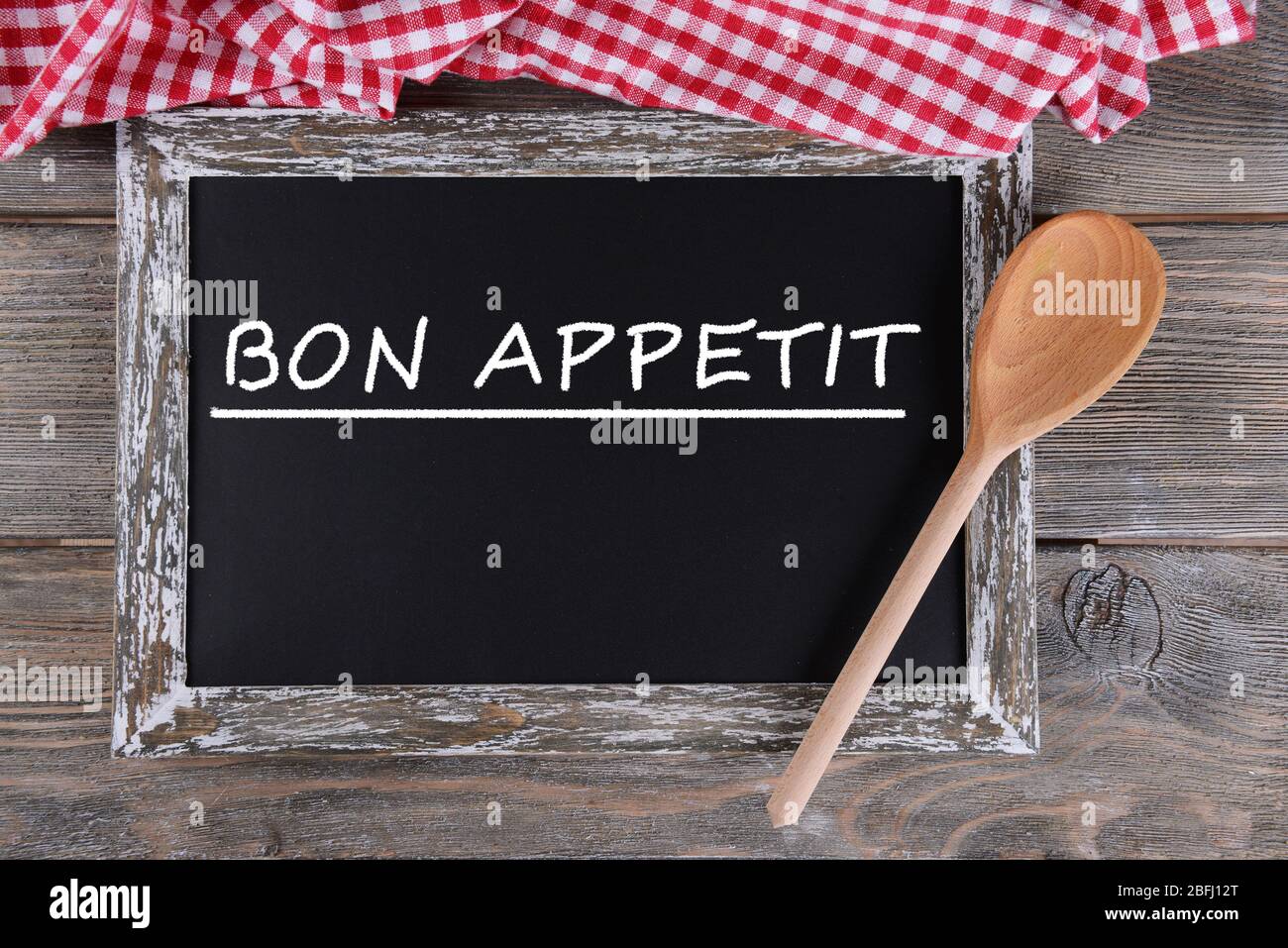 Bon appetit written on chalkboard, close-up Stock Photo