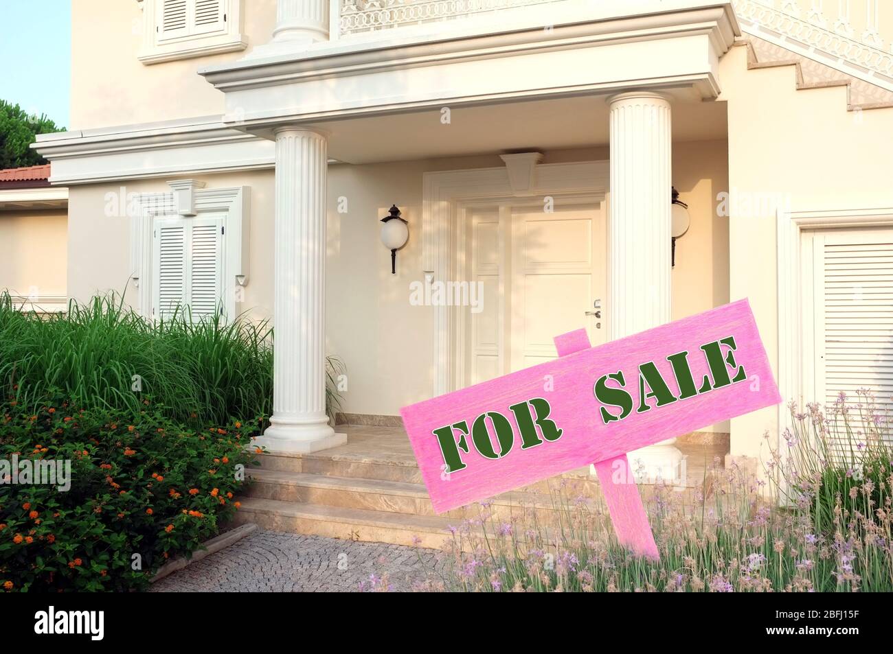 Real estate sign in front of new house for sale Stock Photo - Alamy