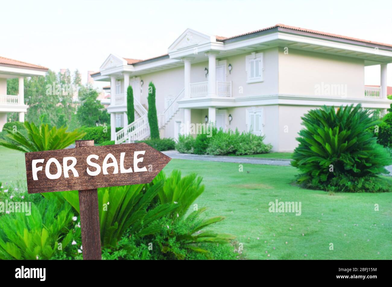 Real estate sign in front of new house for sale Stock Photo - Alamy
