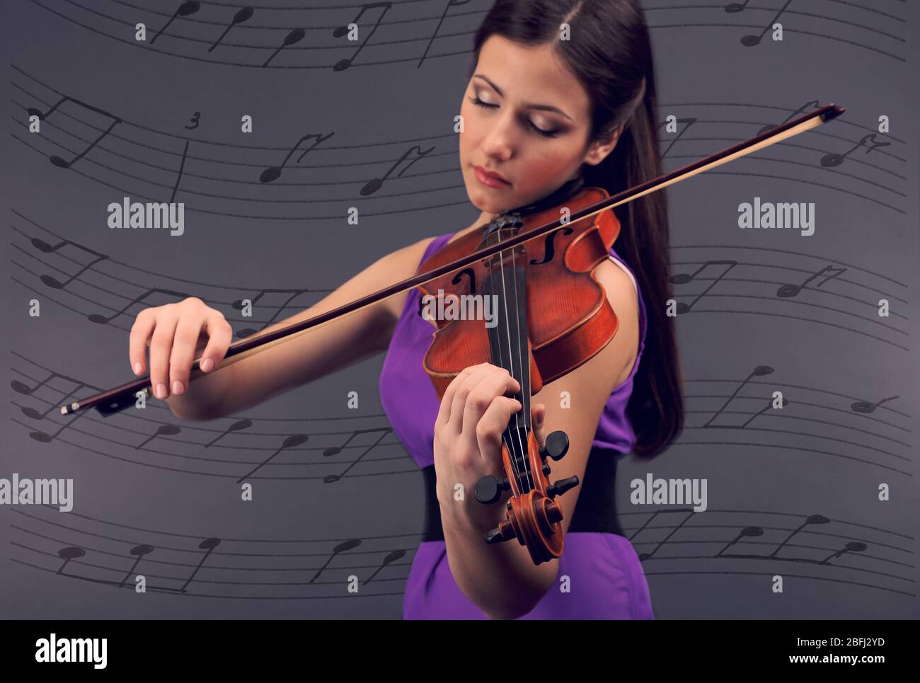 Beautiful young girl with violin on grey background Stock Photo - Alamy