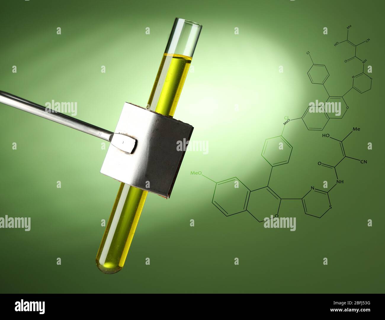 Laboratory test tube filled color liquid held in specialized clamp during scientific experiment