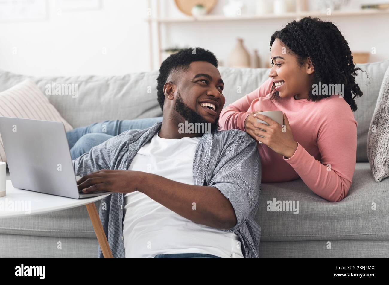 Home Leisure. Happy African American Couple Relaxing With Laptop And ...
