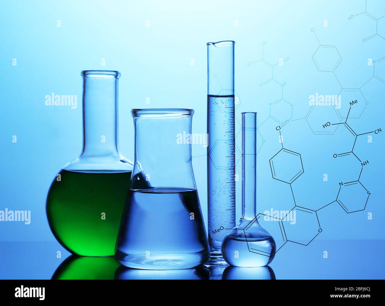 Test tubes with liquid on blue background Stock Photo - Alamy
