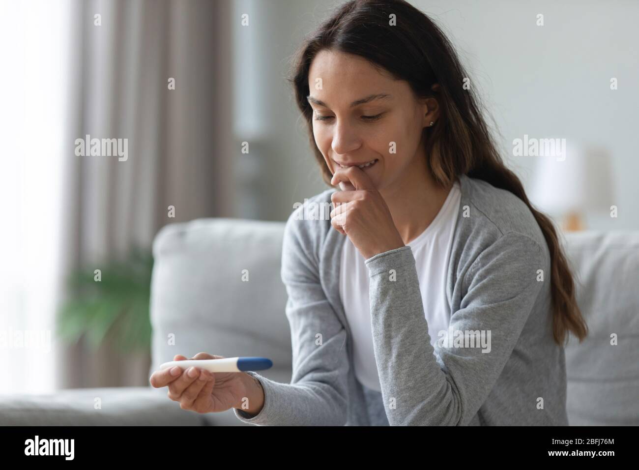 Nervous young woman waiting for pregnancy test result close up Stock Photo