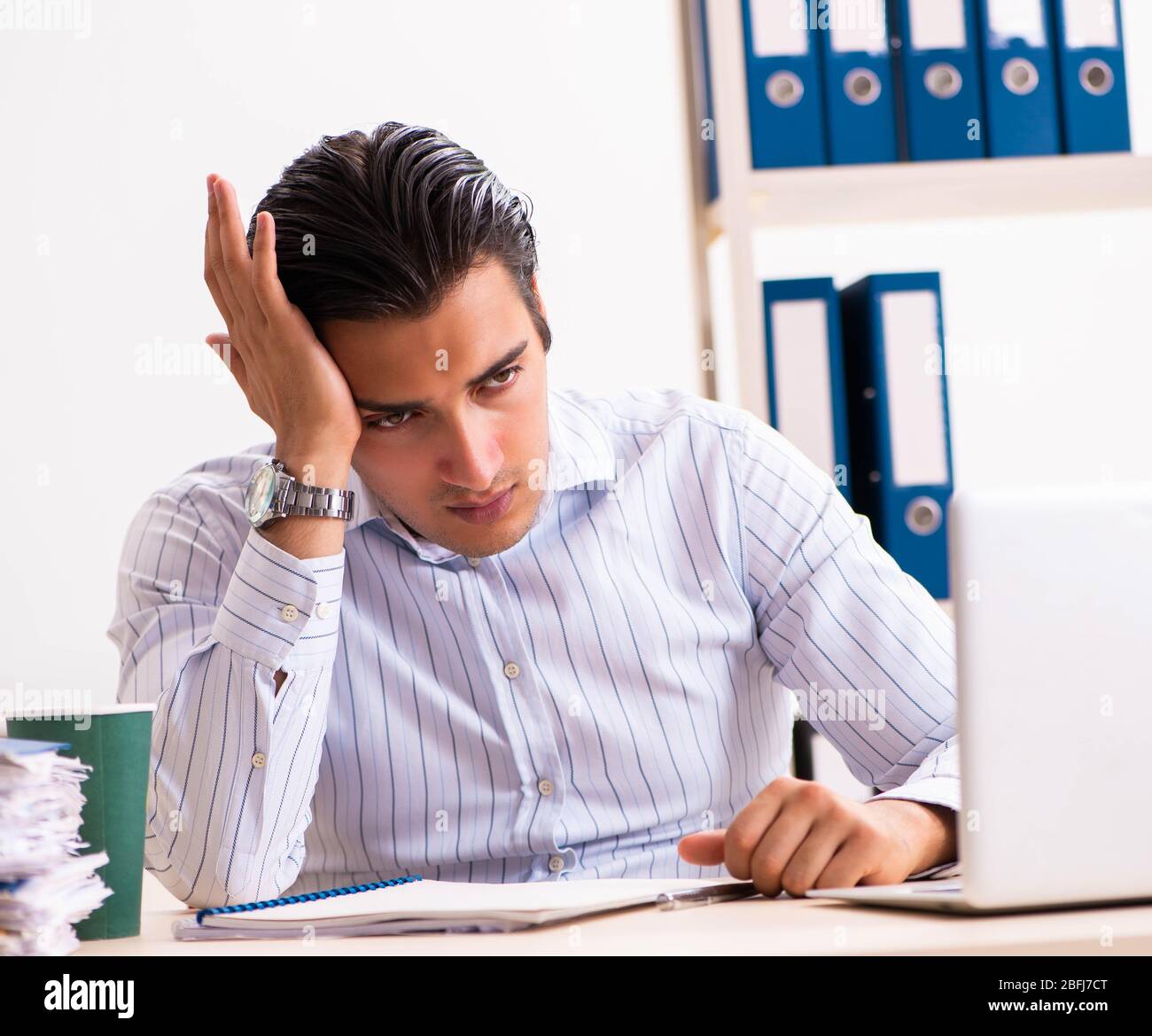 The young employee sitting at the office Stock Photo - Alamy