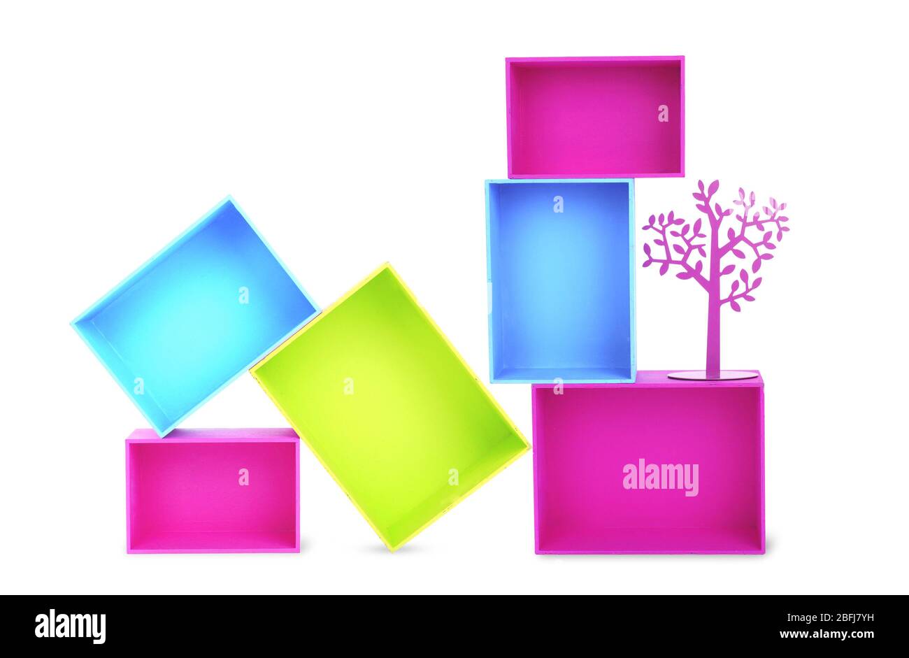 Multicoloured wooden boxes and decorative metal tree isolated on white ...