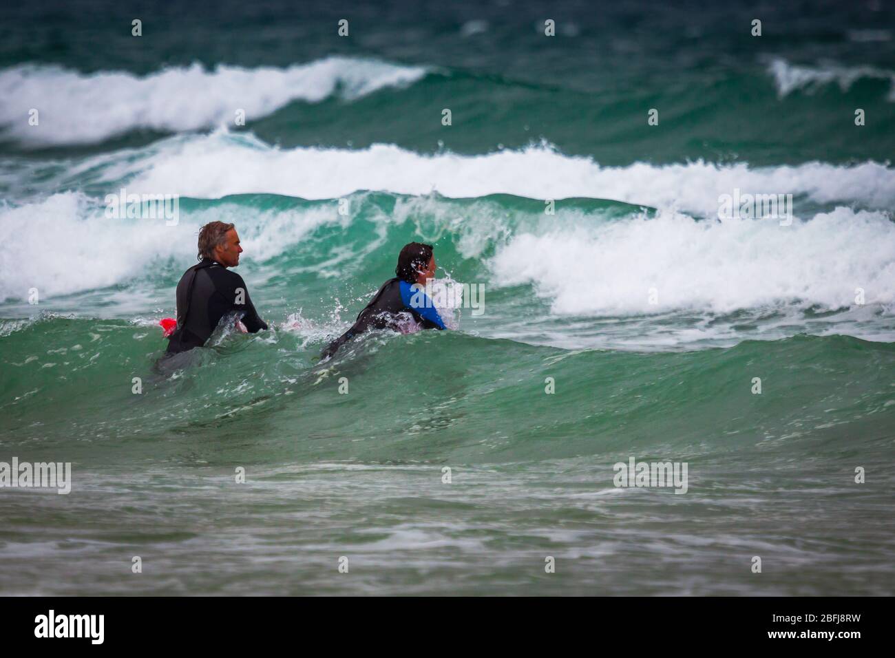 Cornish Surfers enjoying the white waters Stock Photo