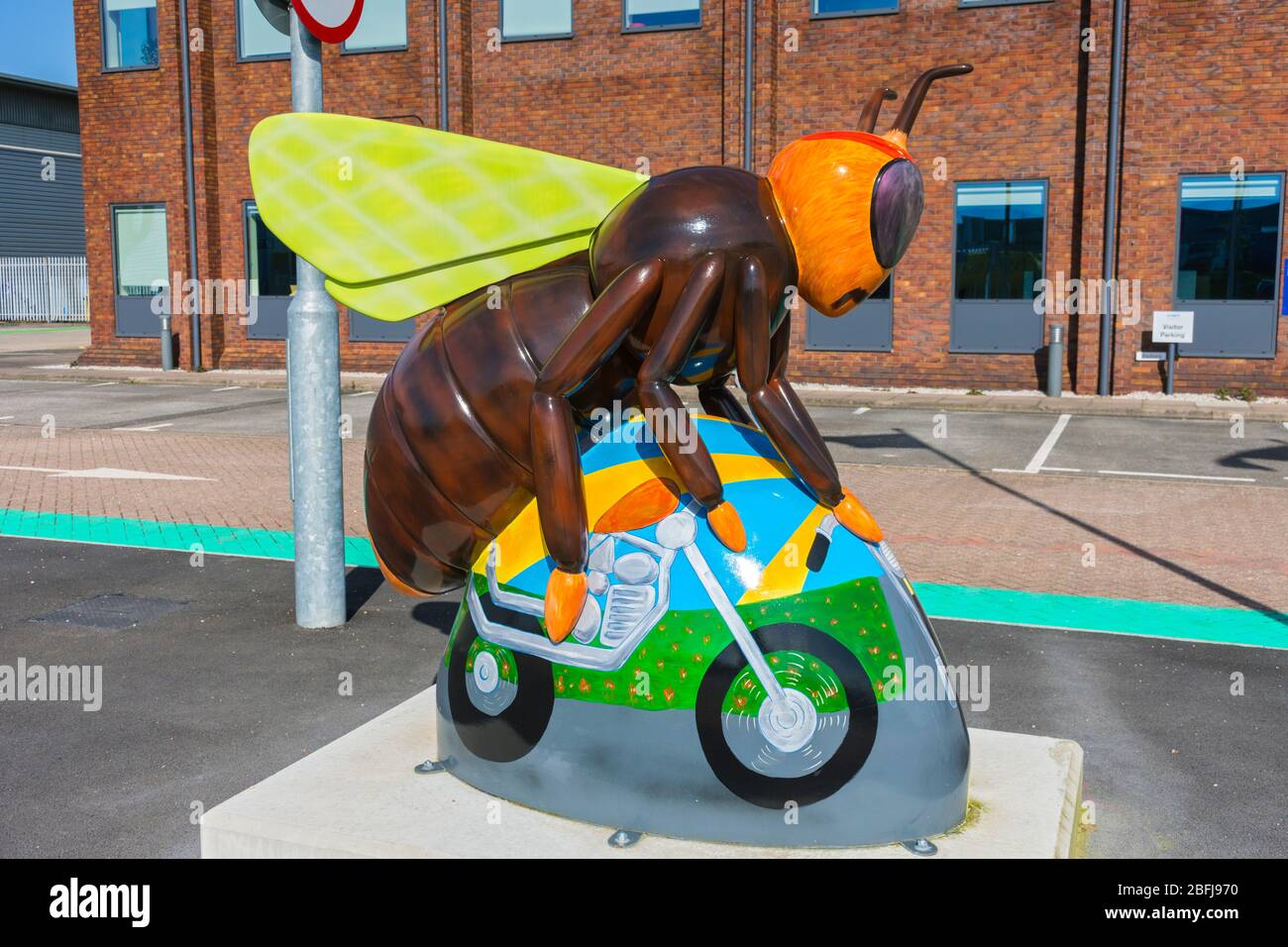 Bee-sy Rider, by Anne-Marie Byrne.  One of the Bee in the City sculptures, now outside an office building on Village Way, Trafford, Manchester, UK Stock Photo
