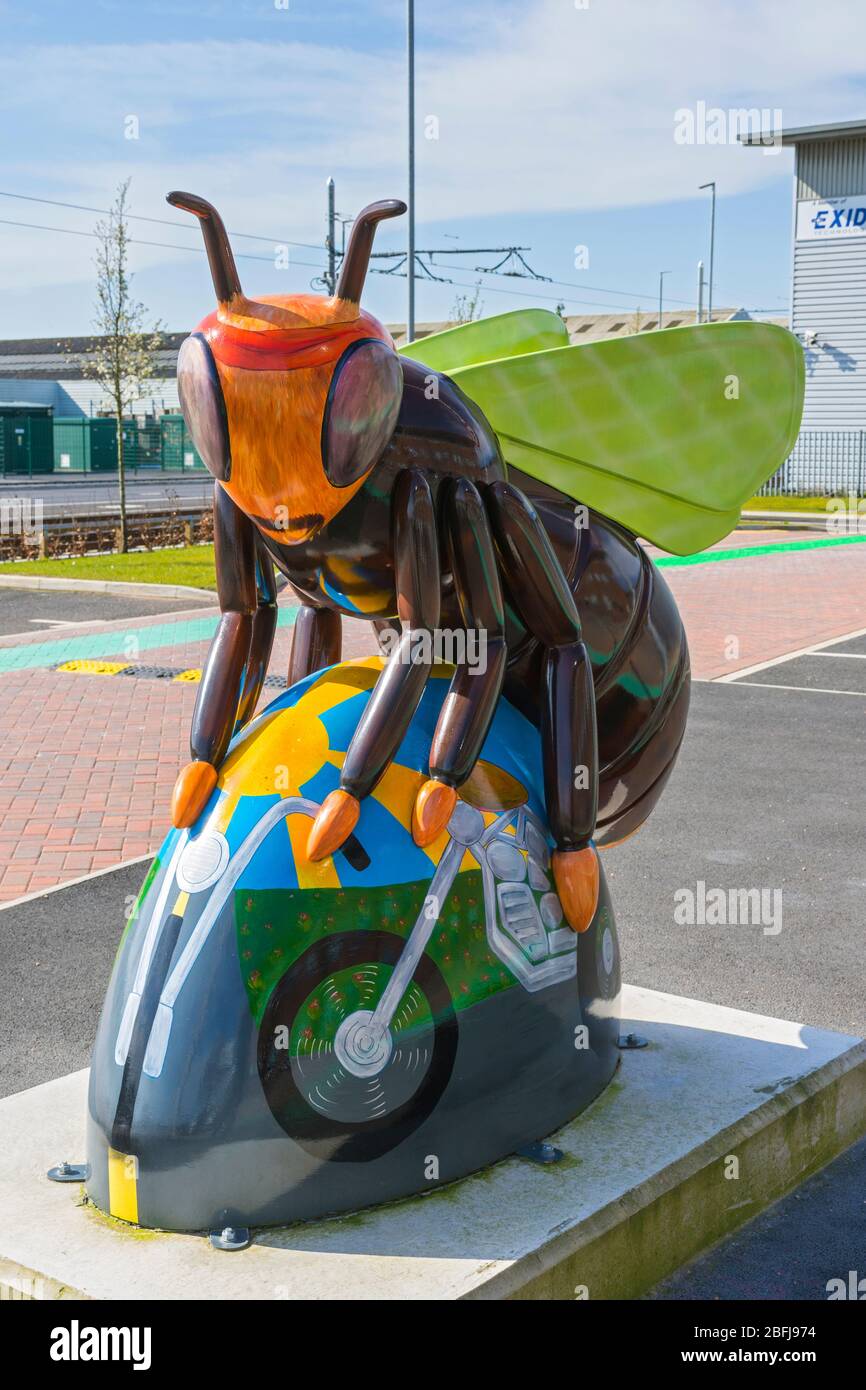 Bee-sy Rider, by Anne-Marie Byrne.  One of the Bee in the City sculptures, now outside an office building on Village Way, Trafford, Manchester, UK Stock Photo