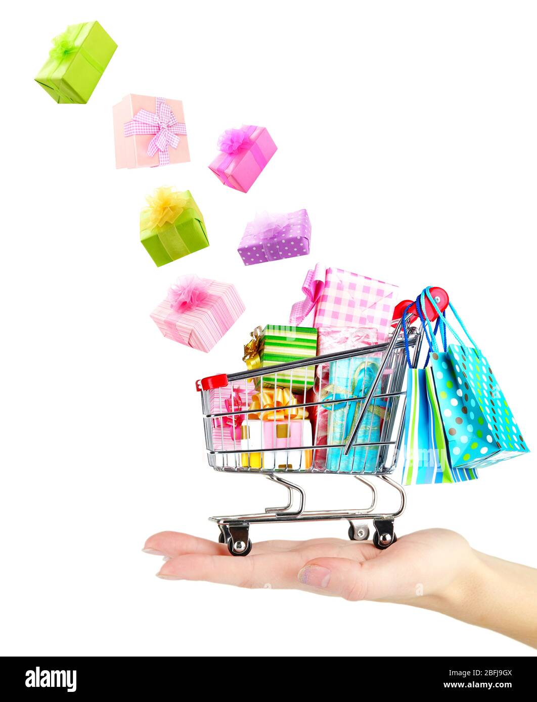 Gift boxes falling into cart isolated on white Stock Photo