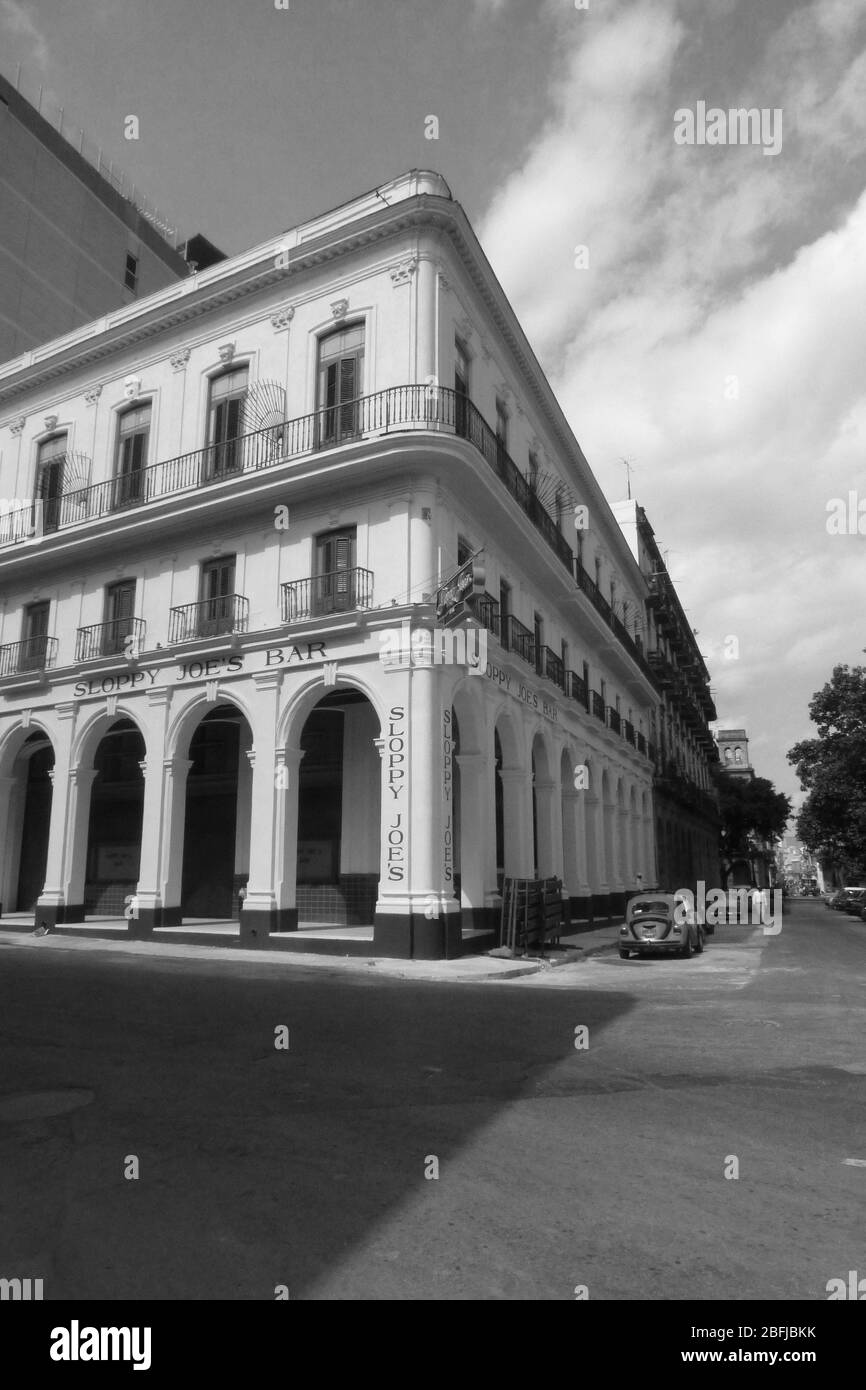 Havana Cuba house arch arches balcony Sloppy Joes  Restaurant car cars clouds weather Colonial Artwork Architecture pillars style type corner design Stock Photo