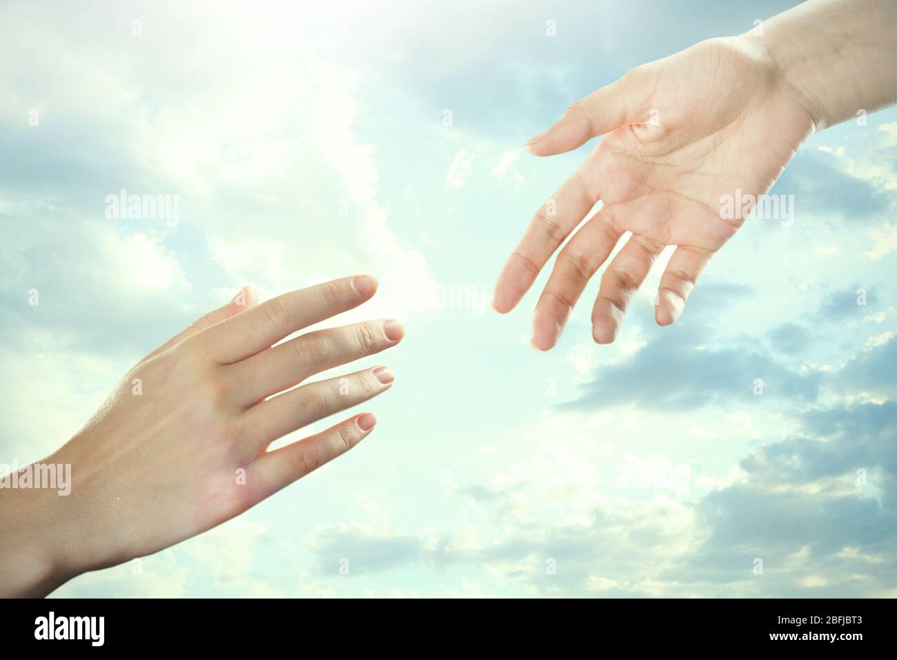 Human hands on sky background Stock Photo - Alamy