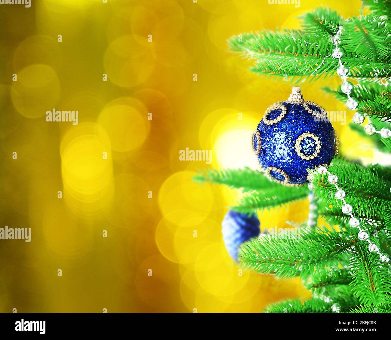 Decorated Christmas tree on festive shiny background Stock Photo - Alamy