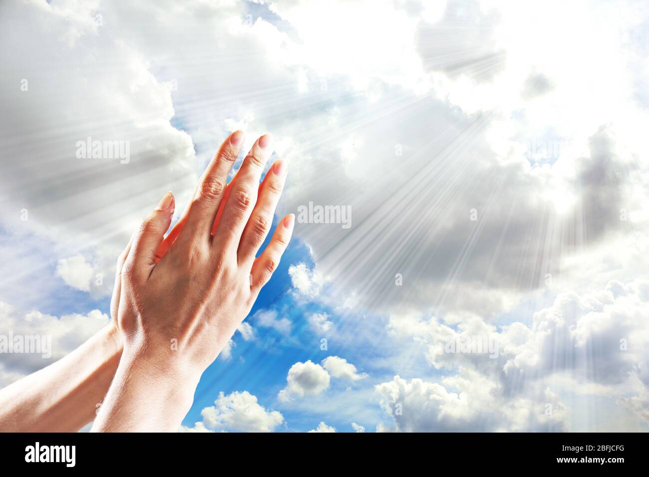 Human hands on sky background Stock Photo - Alamy