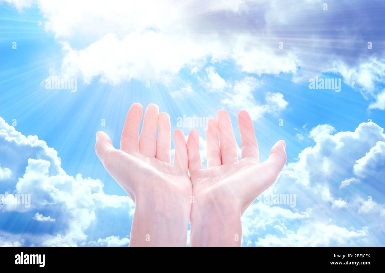Human hands on sky background Stock Photo - Alamy