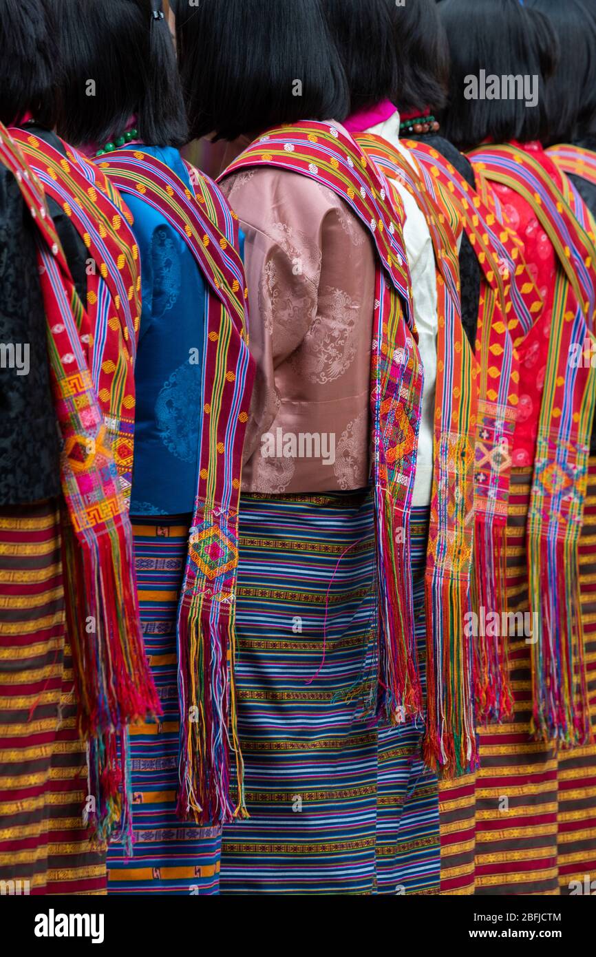 Bhutan, Punakha Dzong. Punakha Drubchen Festival, female dancers in traditional colorful attire. Stock Photo