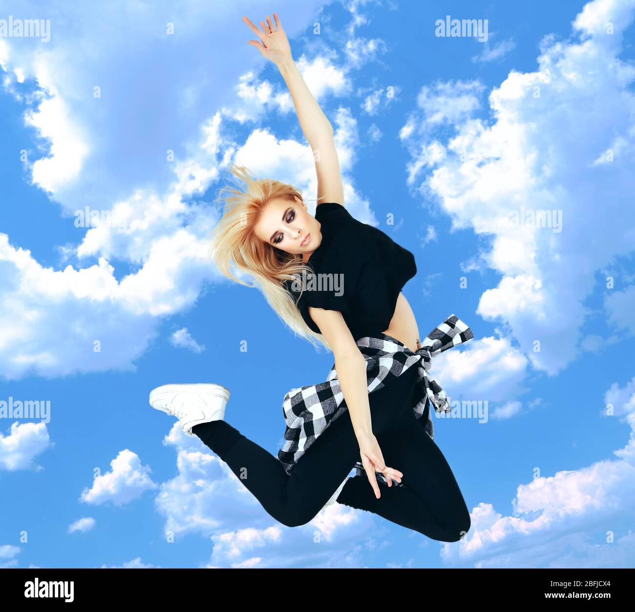 Jumping woman on sky background Stock Photo - Alamy