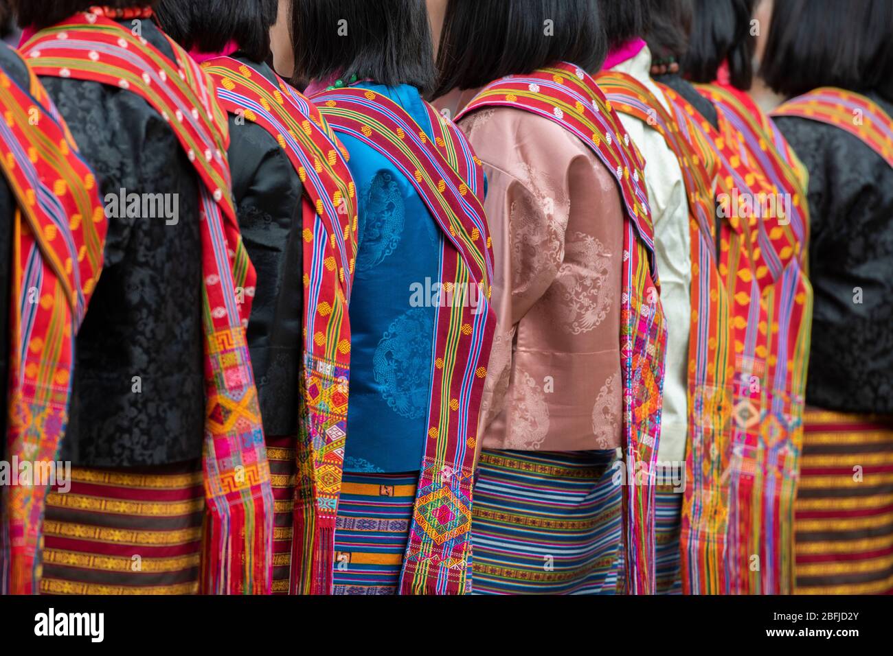Bhutan, Punakha Dzong. Punakha Drubchen Festival, female dancers in traditional colorful attire. Stock Photo