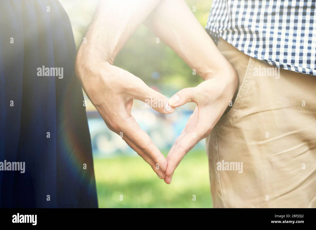 Loving couple holding hands in shape of heart, close-up Stock Photo - Alamy