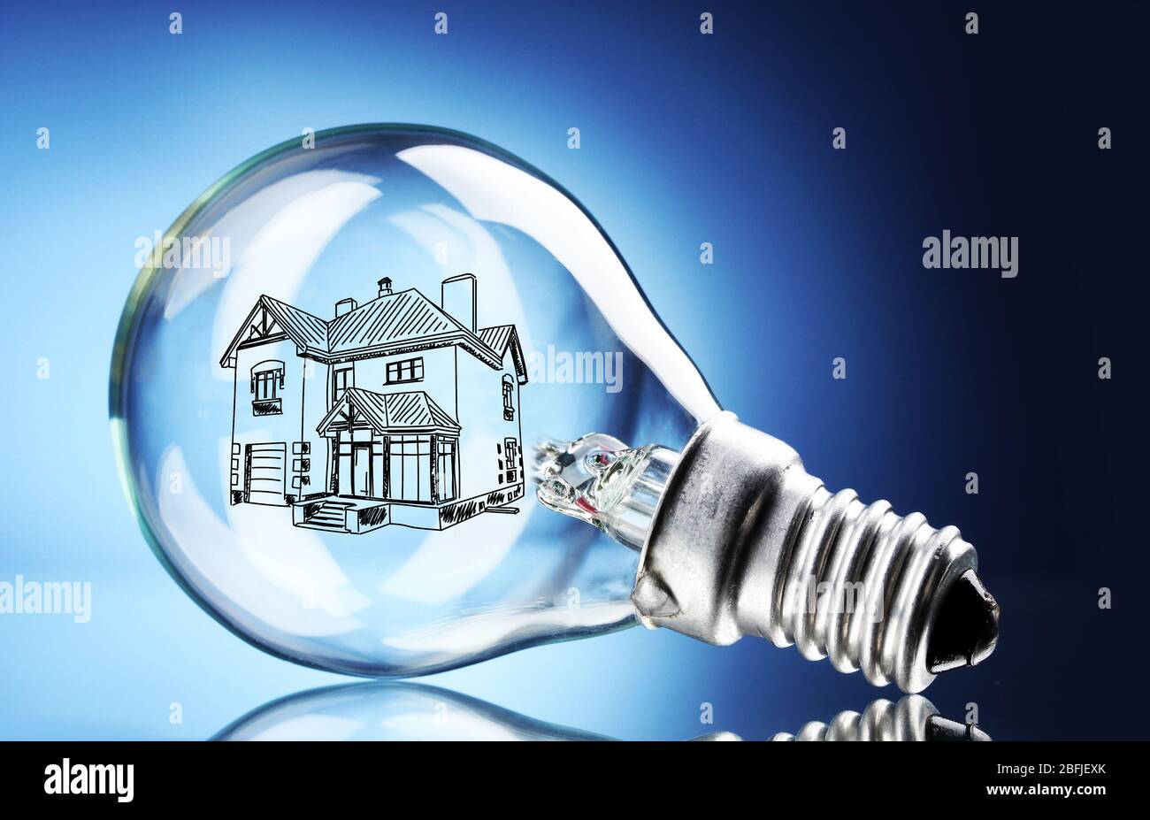 Light bulb with house sketch project inside on blue background Stock Photo Alamy