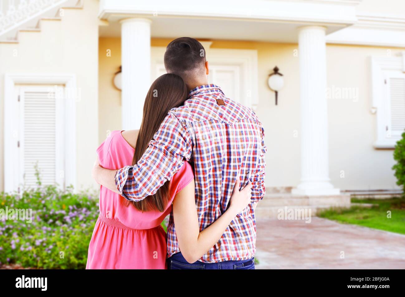 Loving couple looking at their dream house Stock Photo - Alamy