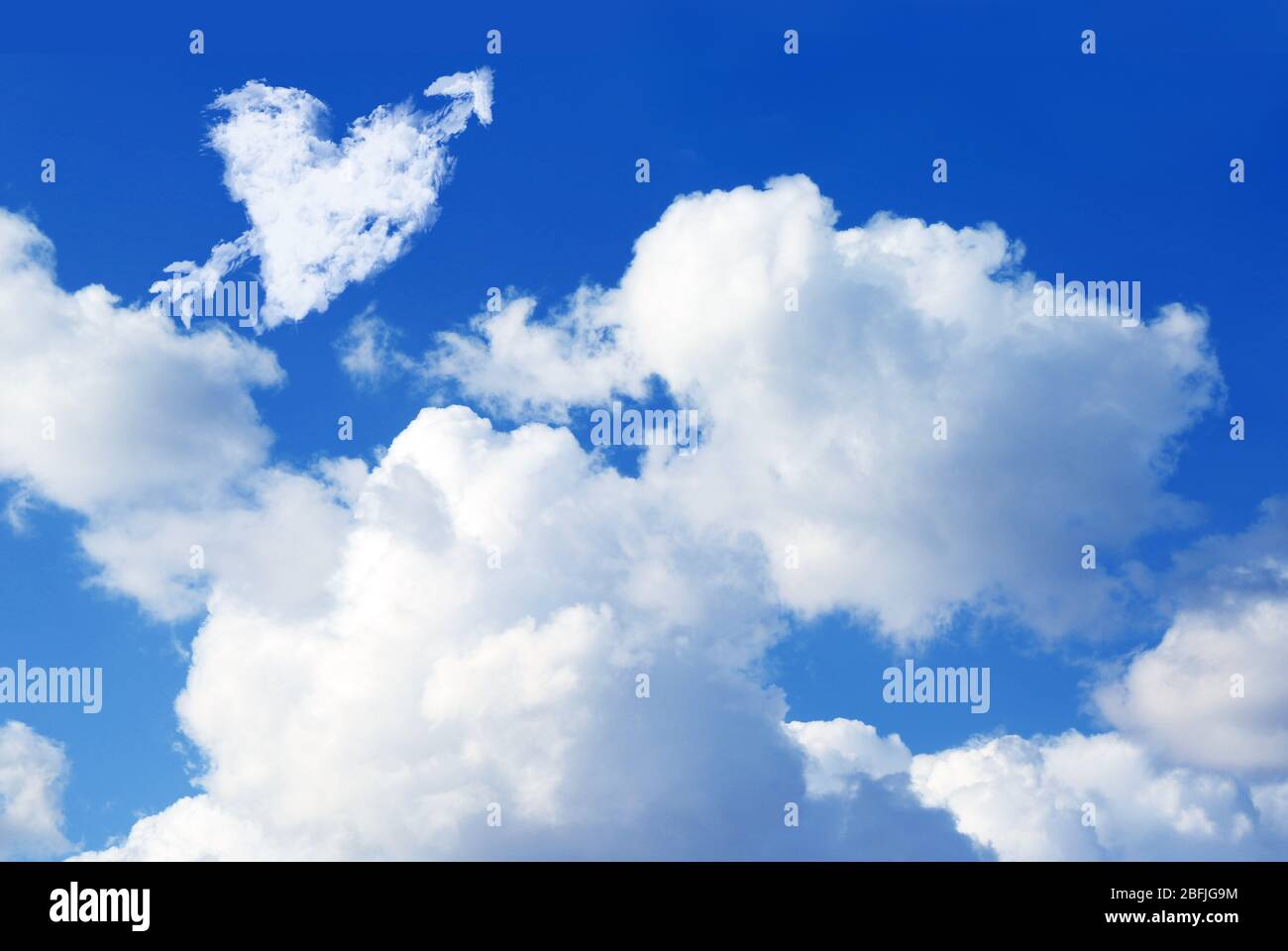 White cloud in shape of heart on blue sky background Stock Photo - Alamy