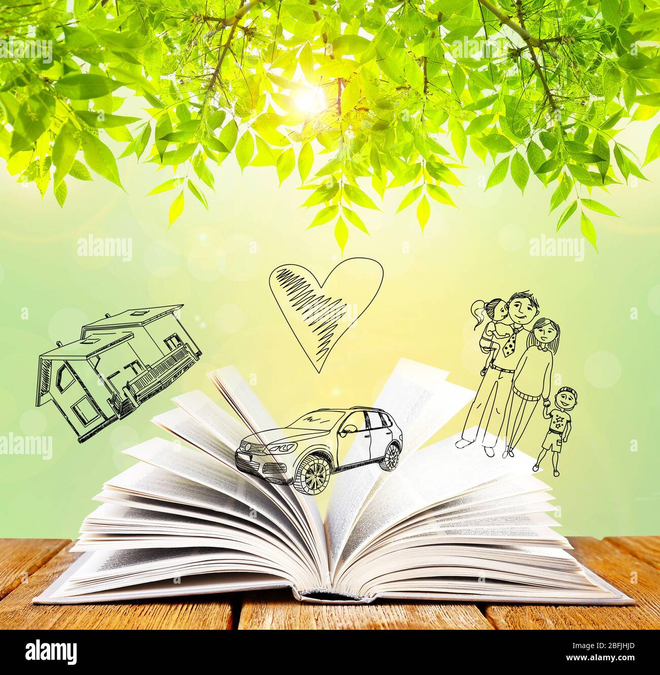 Open book with drawings on nature background Stock Photo