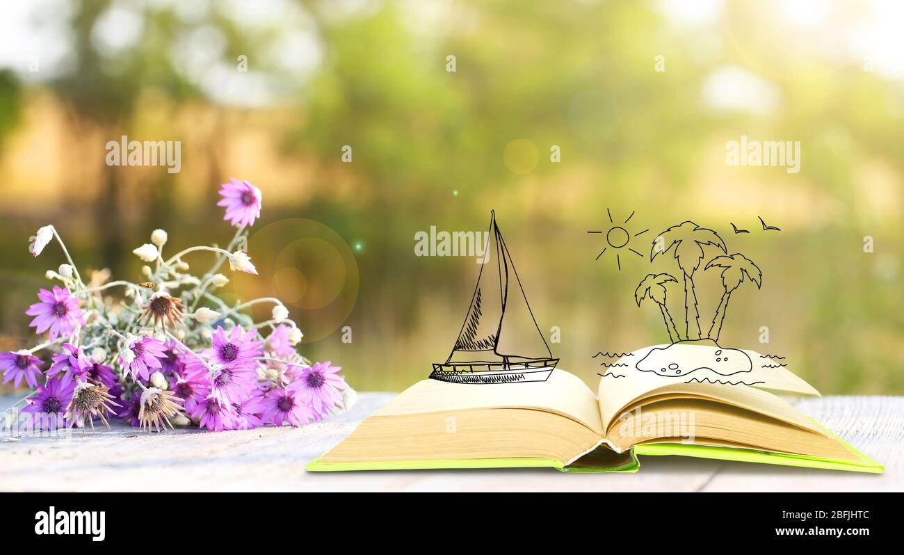 Open book with drawings on nature background Stock Photo