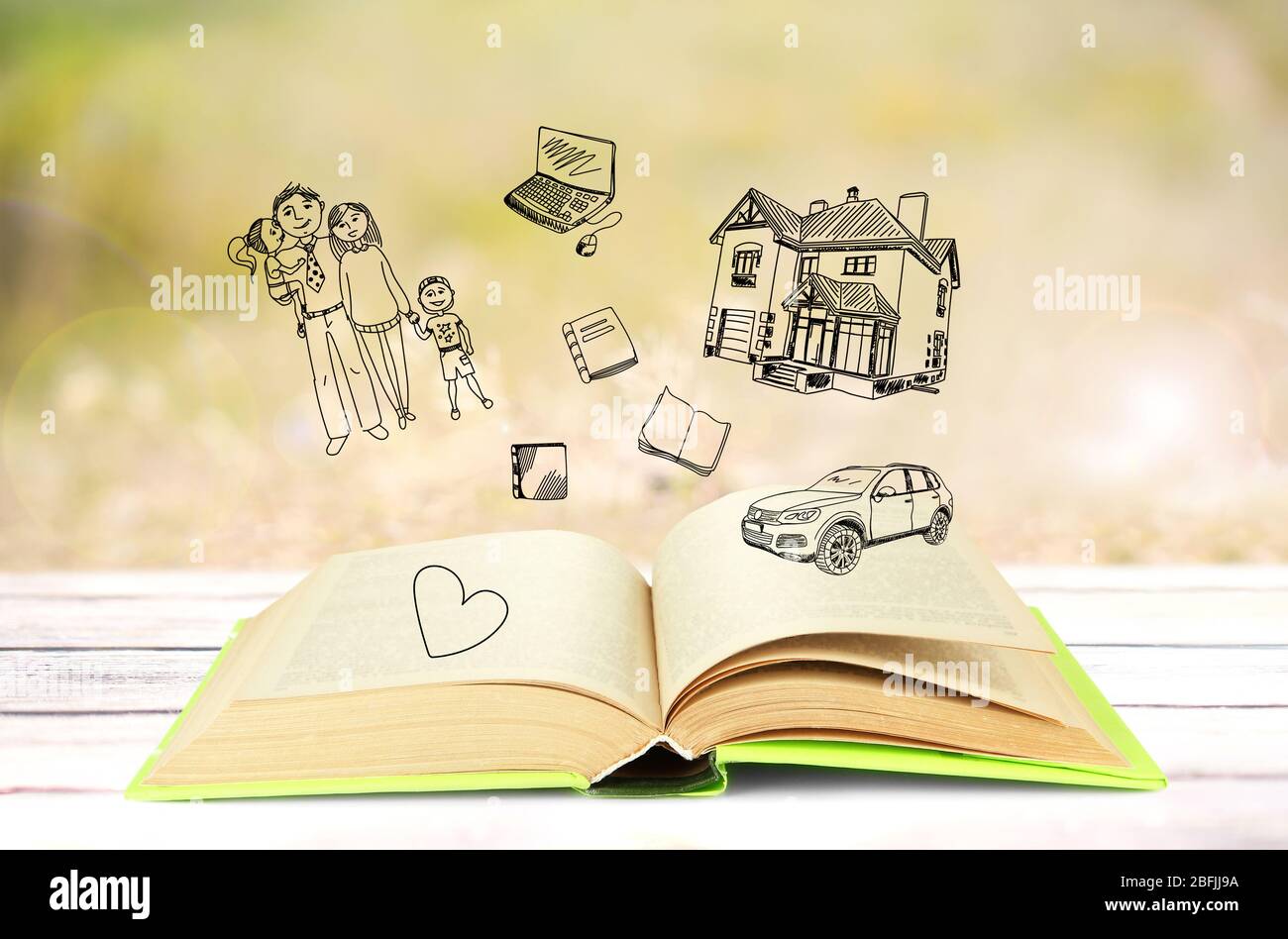 Open book with drawings on light background Stock Photo