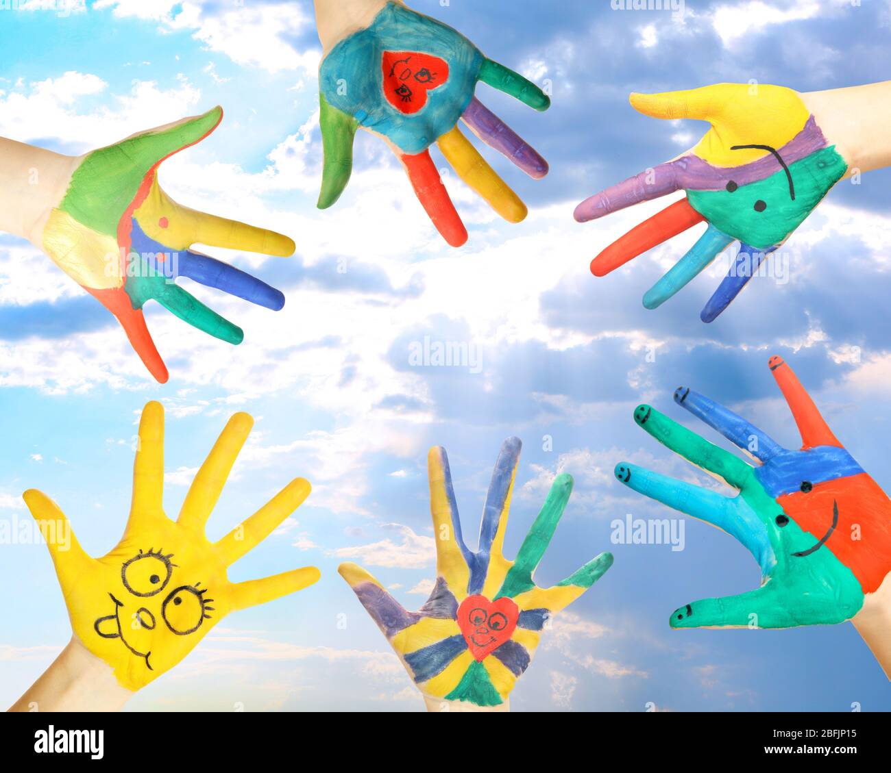 Painted hands on sky background Stock Photo - Alamy
