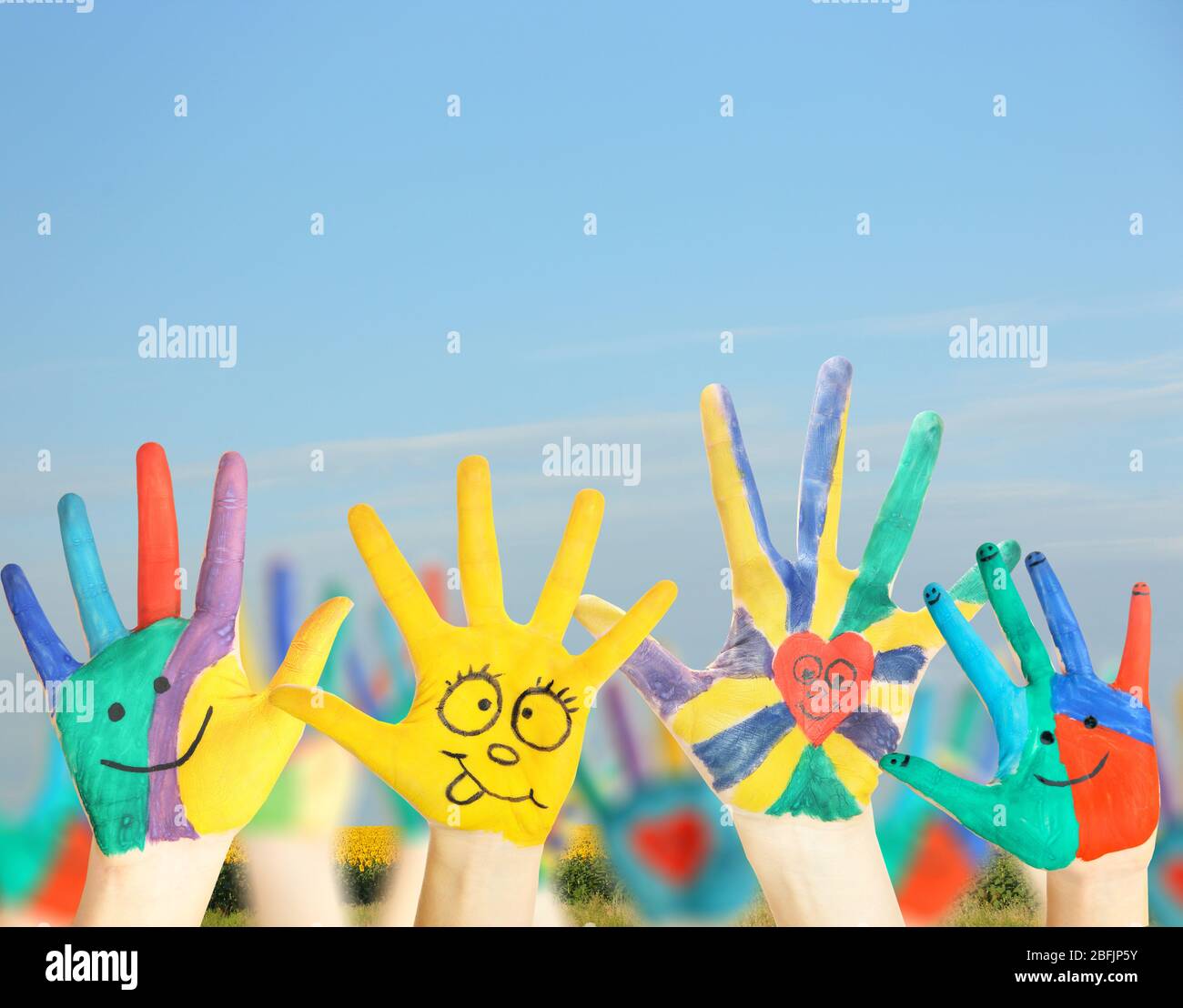 Painted hands on sky background Stock Photo - Alamy