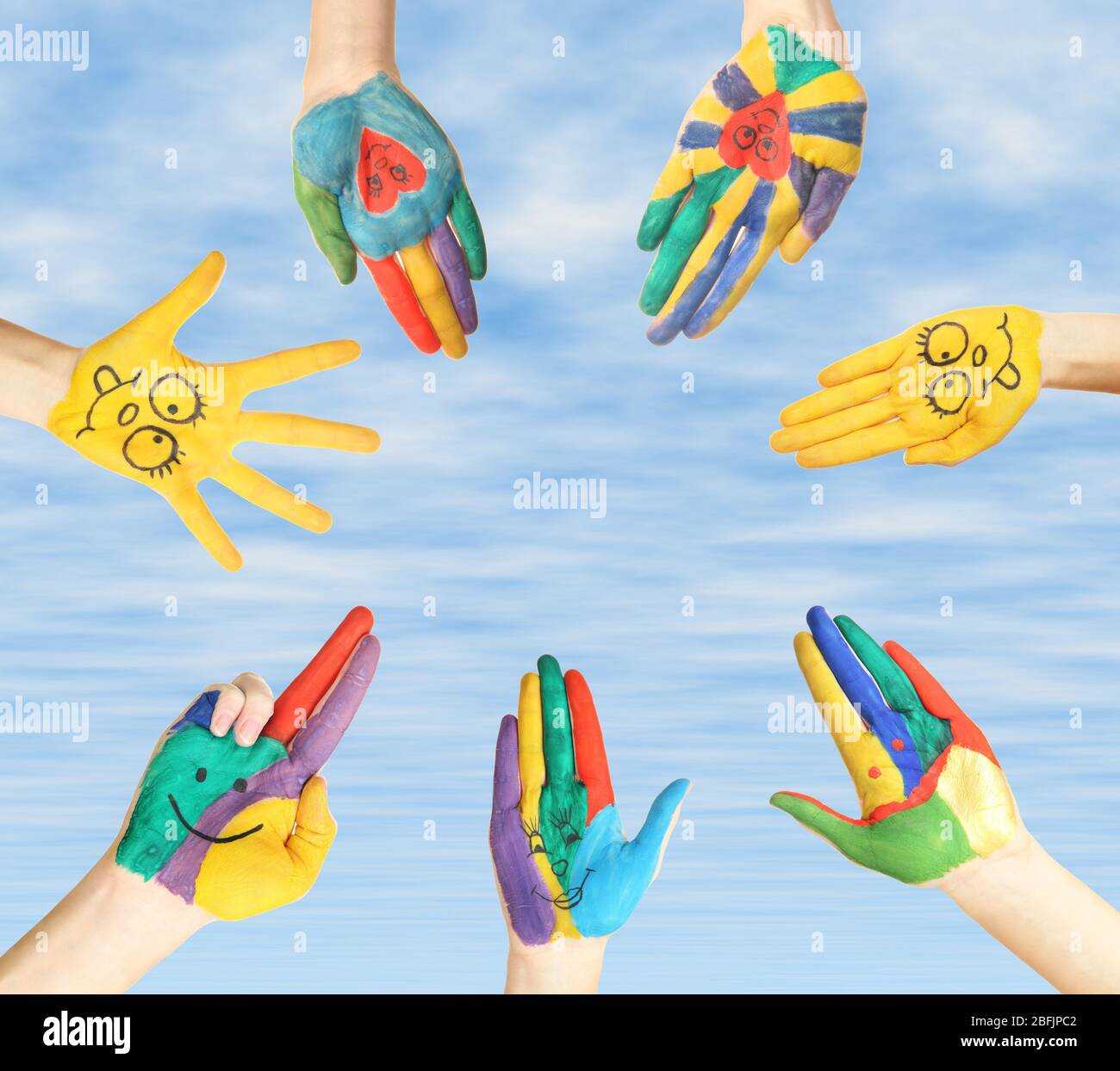 Painted hands on sky background Stock Photo - Alamy