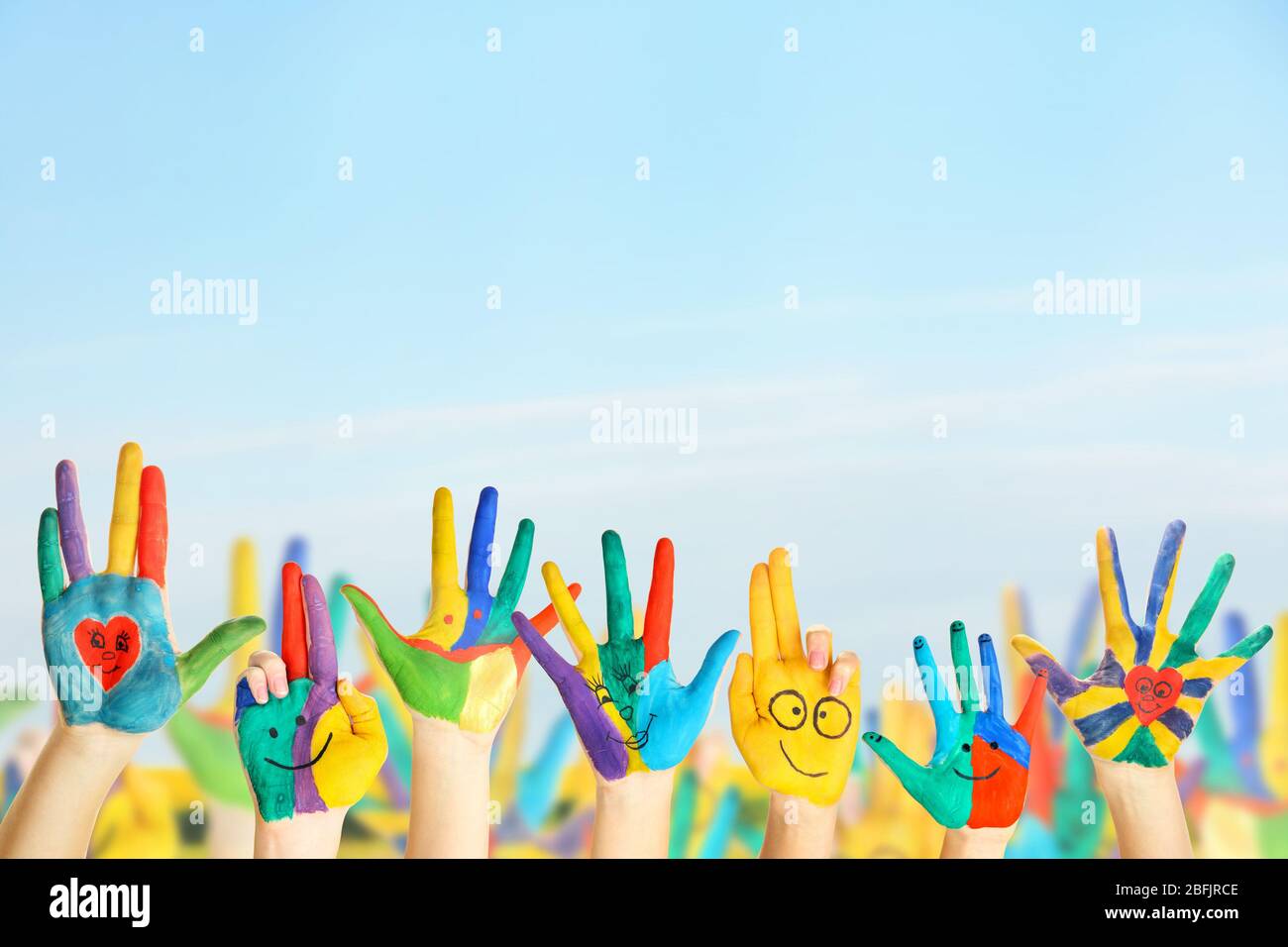 Painted hands on sky background Stock Photo - Alamy