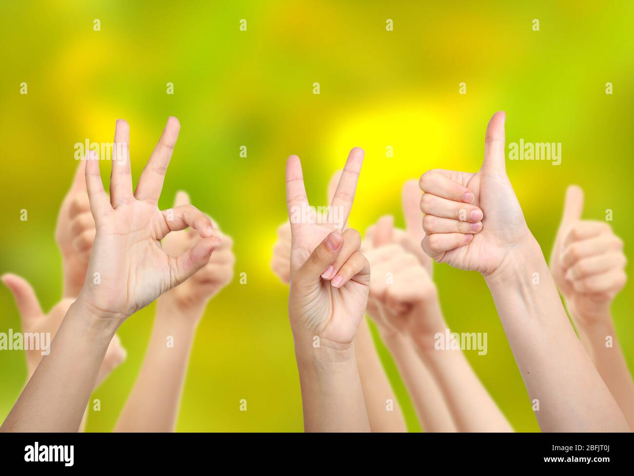 Young people's hands on bright background Stock Photo - Alamy