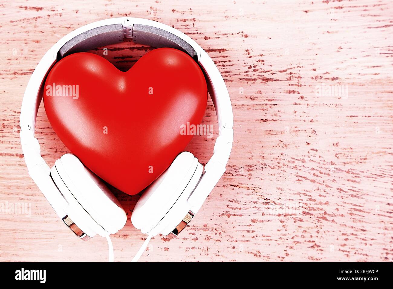 Headphones and heart on color wooden background Stock Photo Alamy