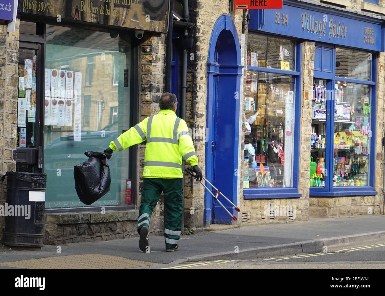 New Mills,  Derbyshire  April 19th 2020  Bin emptying  is one of local councils' responsibilities,  even during lockdown, due to the coronavirus pandemic. Stock Photo