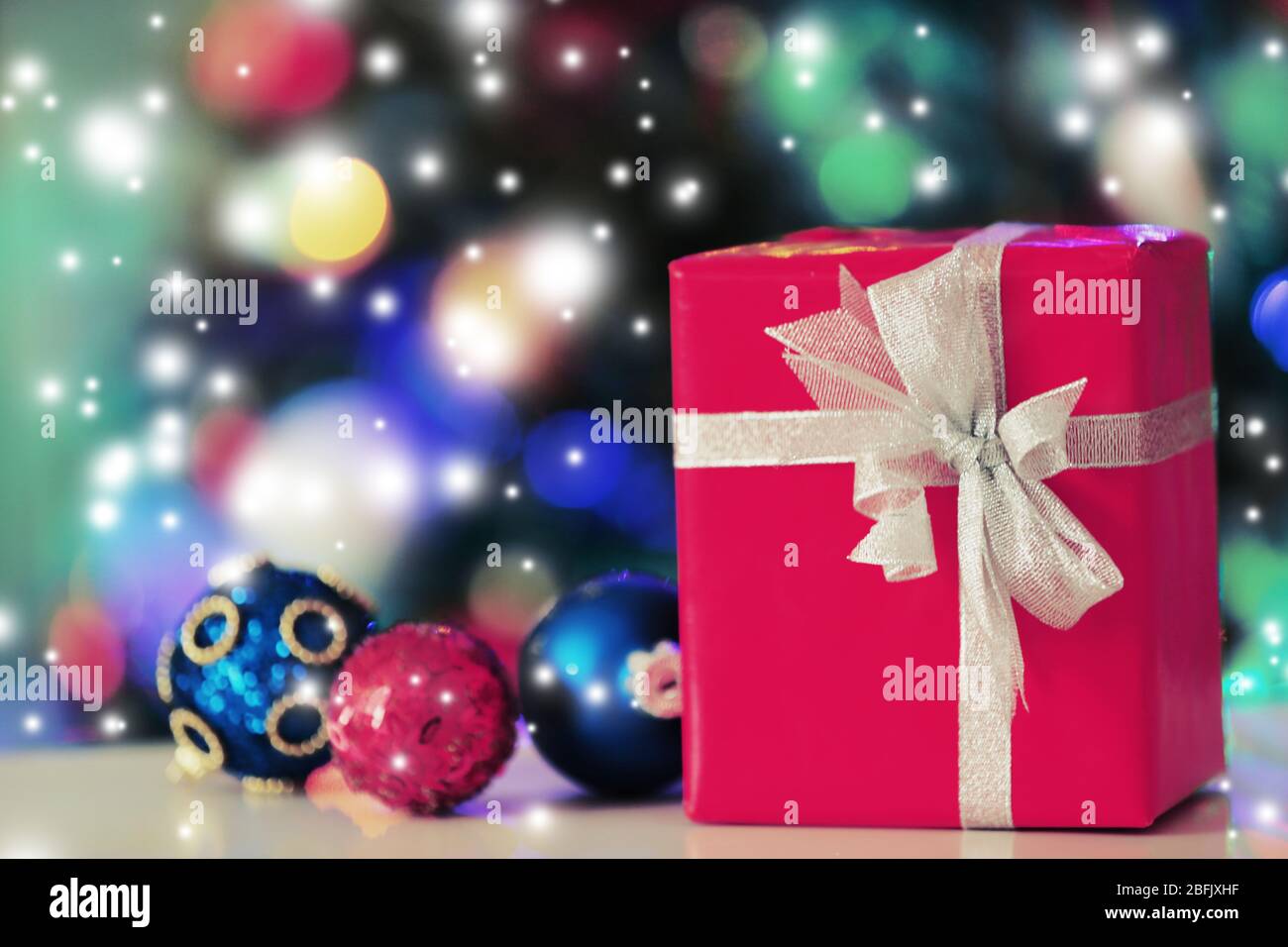 Christmas gift box and decorations on lights background Stock Photo