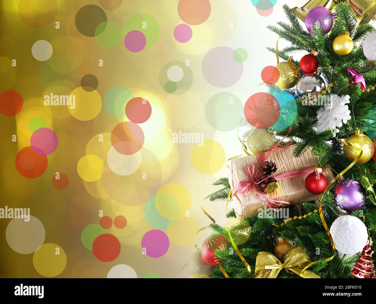Decorated Christmas tree on festive shiny background Stock Photo - Alamy