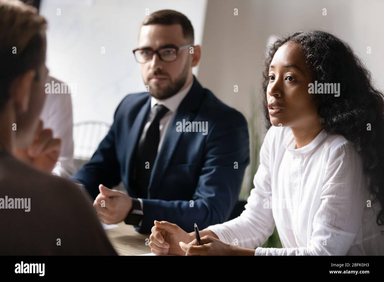 Multicultural businesspeople brainstorm cooperate at office briefing Stock Photo