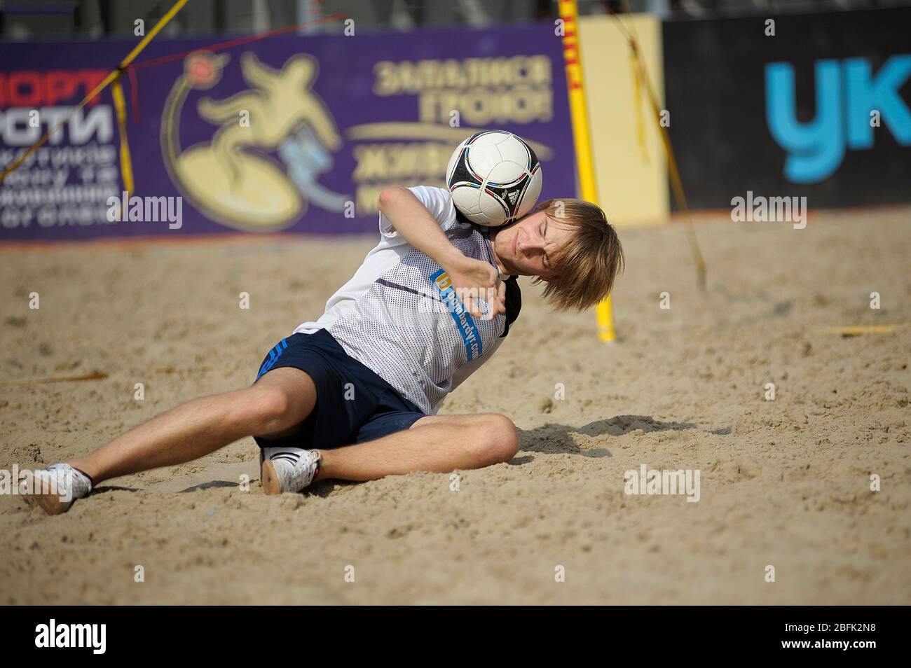 Young boy juggling with the soccer ball on the beach stadium Stock Photo Alamy
