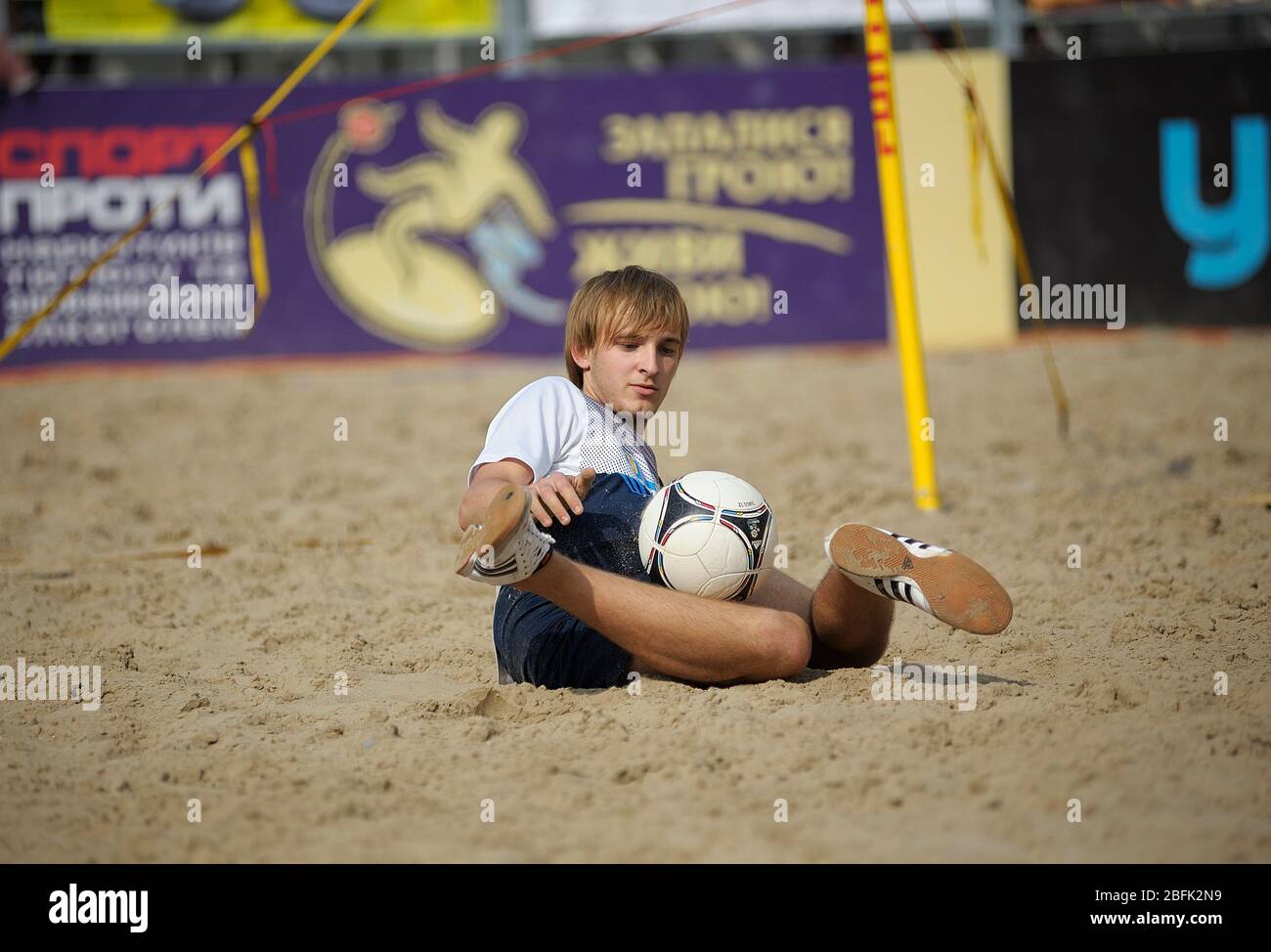 Young boy juggling with the soccer ball on the beach stadium Stock Photo Alamy