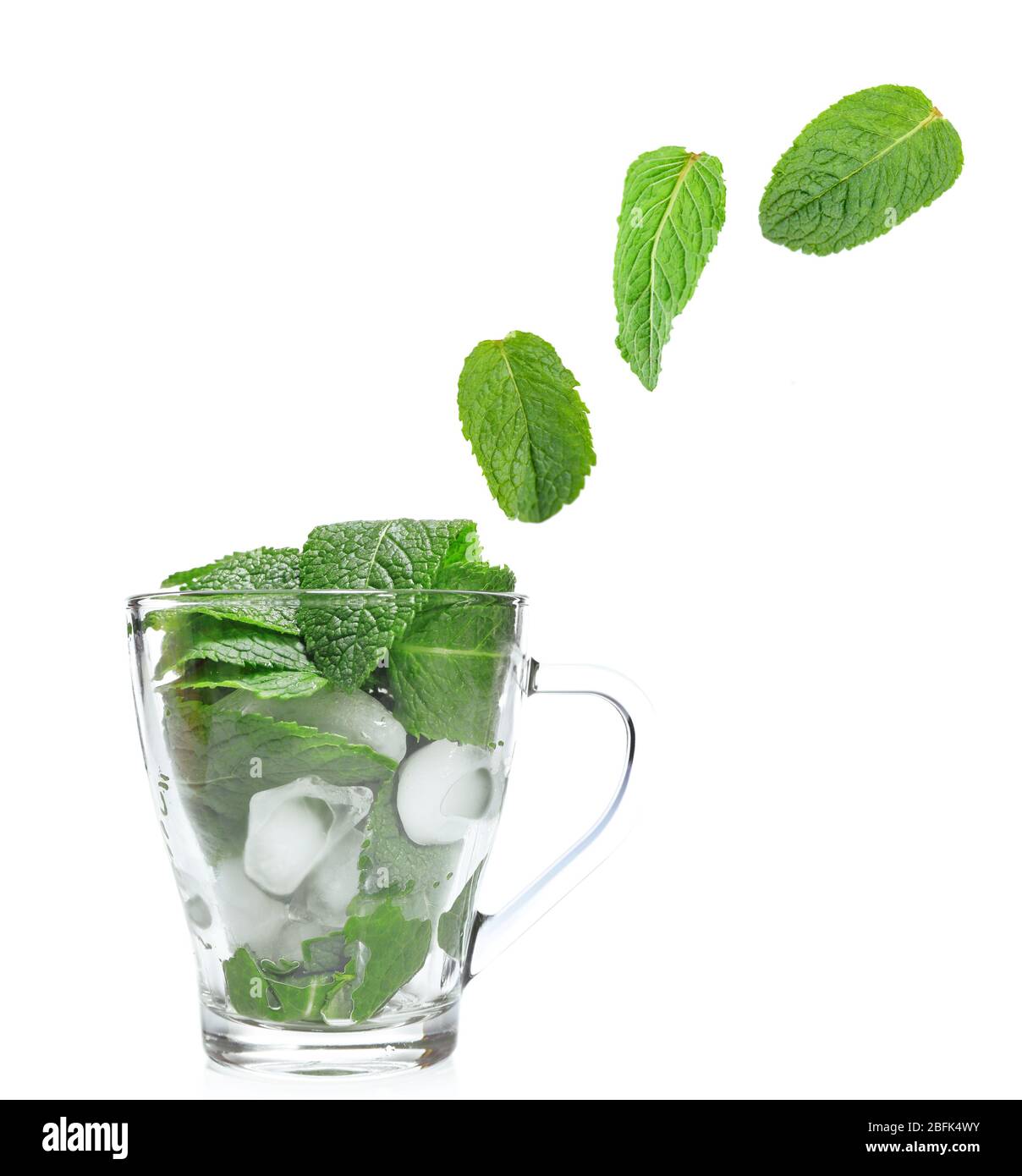 Mints Falling Mint leaves falling in glass cup isolated on white Stock Photo - Alamy