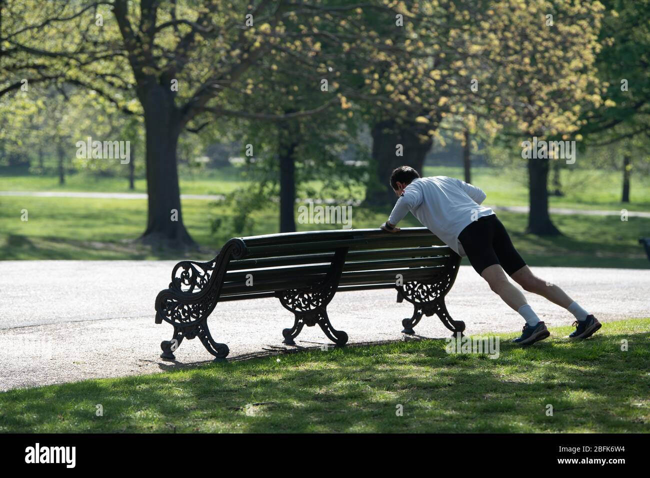 Man exercising in Kensington Park during lockdown as his daily allowance.  Health secretary, Matt Hancock, said the public must resist the urge to flout physical distancing rules to prevent tighter lockdown rules being enforced. Stock Photo