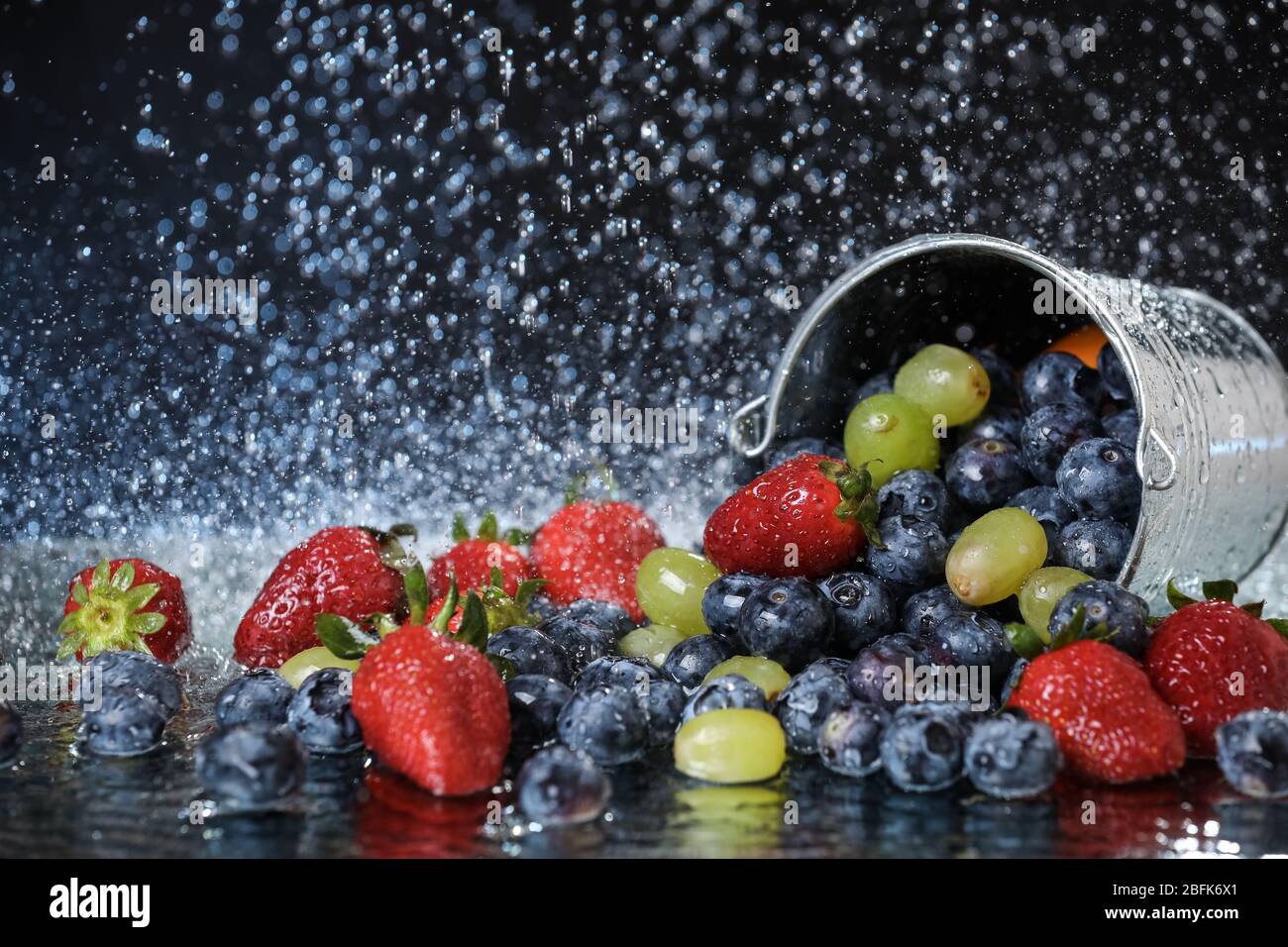Fruit salad close up in metal bucket. Strawberry, grape, blueberry ... Fruit salad close up in metal bucket. Strawberry, grape, blueberry ...