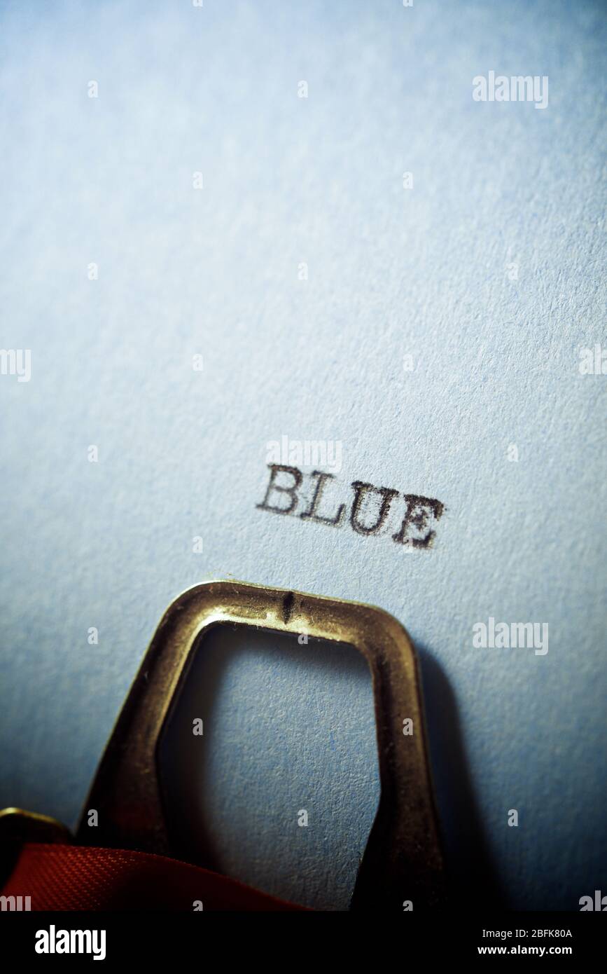 Blue word written on a paper. Stock Photo